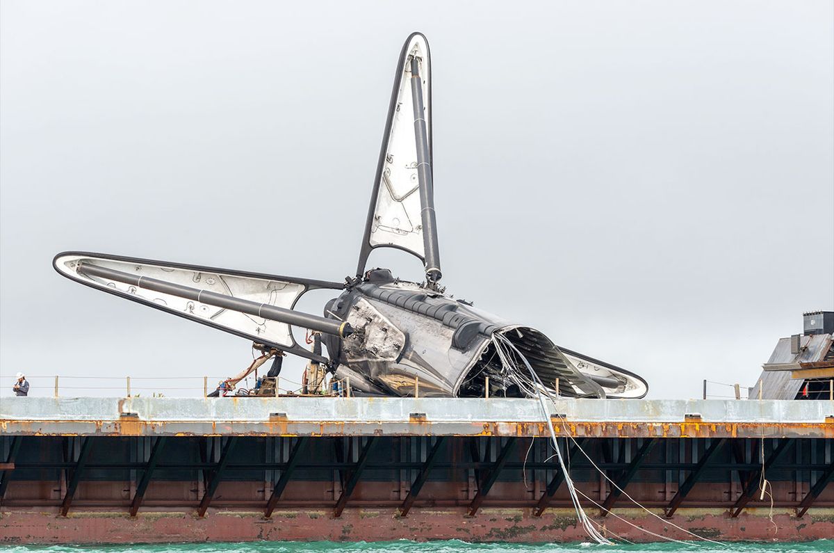 The remains of SpaceX&#039;s first Falcon booster to fly astronauts into orbit are seen atop the droneship &quot;Just Read the Instructions&quot; after a mishap following the stage&#039;s record 19th launch.