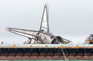 The remains of SpaceX's first Falcon booster to fly astronauts into orbit are seen atop the droneship "Just Read the Instructions" after a mishap following the stage's record 19th launch.