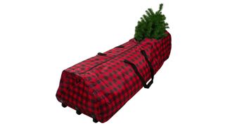 A black and red plaid rolling Christmas tree storage bag laying flat and partially unzipped with a tree branch sticking out, for the best Christmas tree storage bags.