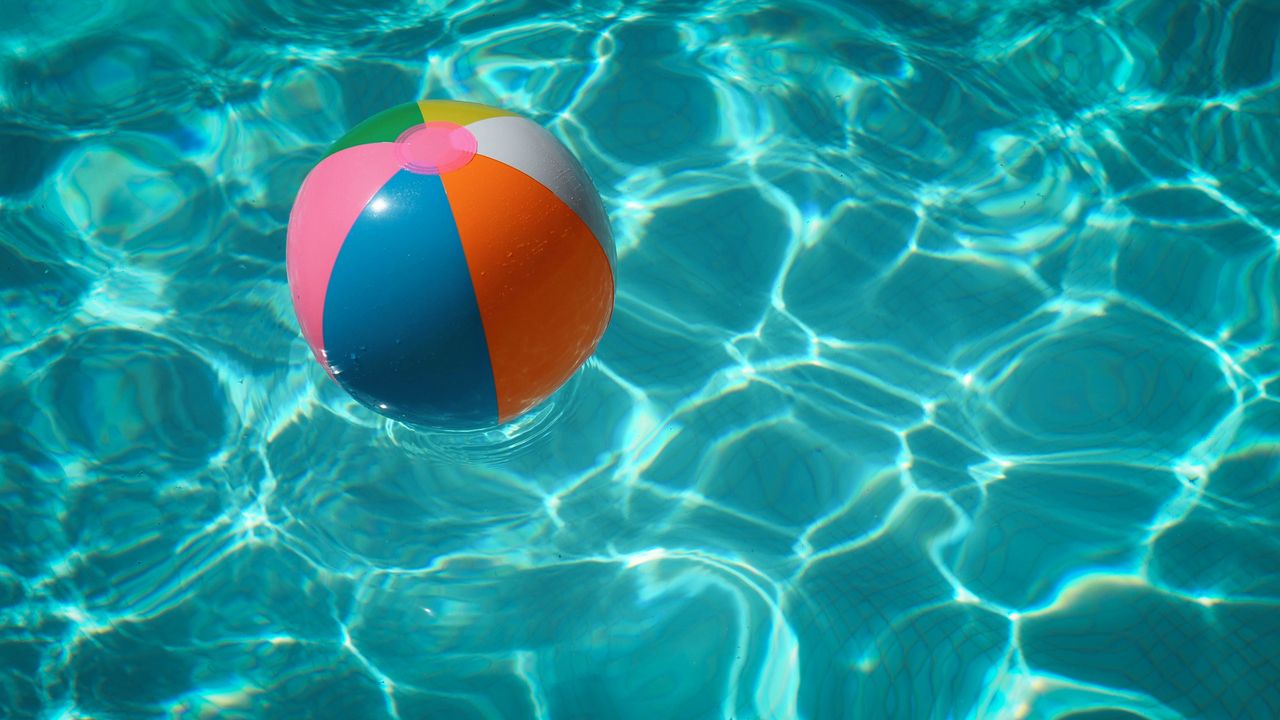 A beach ball in a pool.