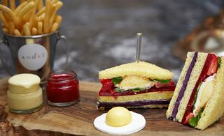Dessert club sandwich, featuring doughnut fries, a lemon meringue fried egg and raspberry coulis ketchup and white chocolate mayo