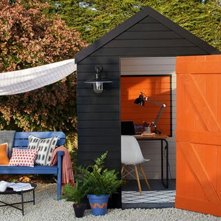 garden shed with cushion and table lamp
