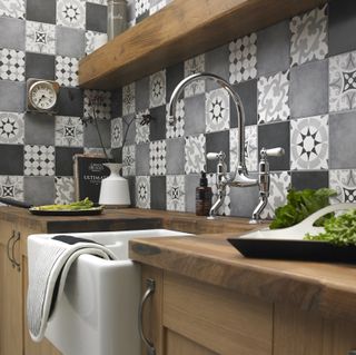 kitchen room with printed tiled walls and kitchen sink
