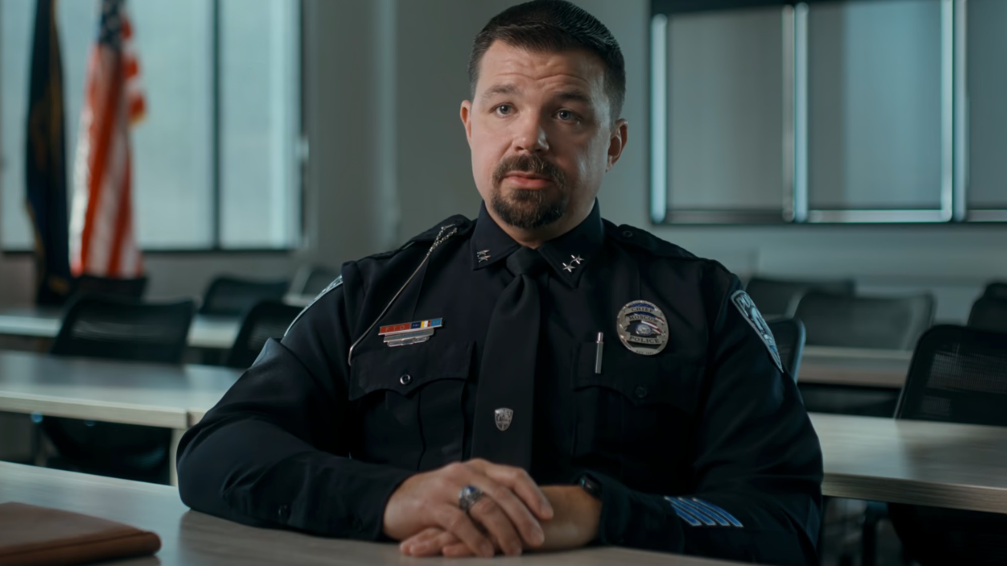A police officer in uniform being interviewed for The Idaho Murders: College Nightmare