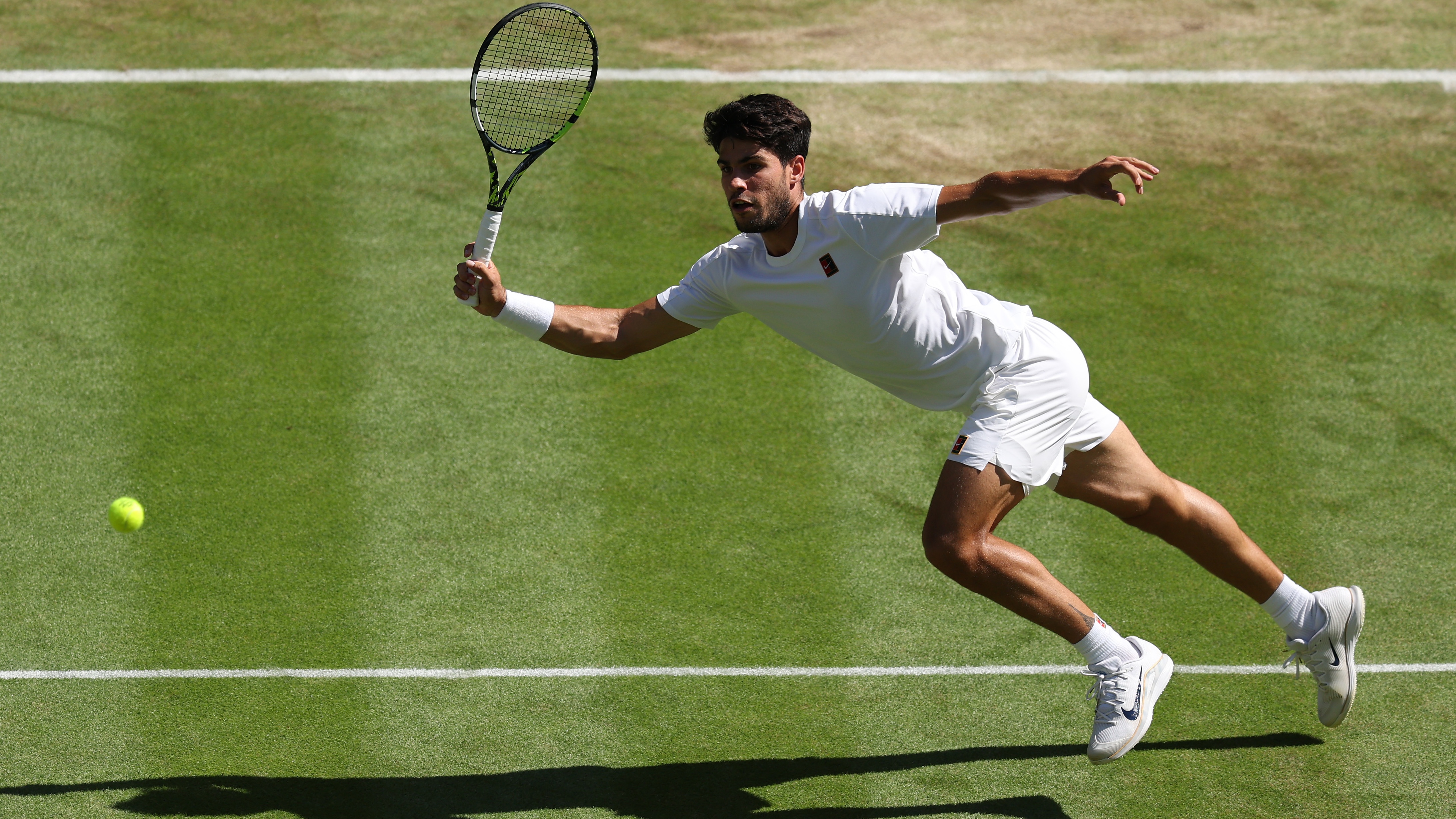 LONDON, ENGLAND - JULY 11: Carlos Alcaraz of Spain plays a forehand volley against Taylor Fritz of United States during the Gentlemen&#039;s Singles semi-final match on day twelve of The Championships Wimbledon 2025 at All England Lawn Tennis and Croquet Club on July 11, 2025 in London, England. (Photo by Clive Brunskill/Getty Images)