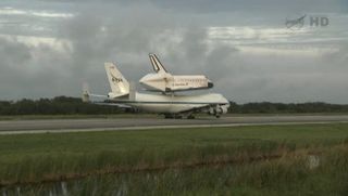 NASA's space shuttle Endeavour, perched atop the Shuttle Carrier Aircraft (a modified 747 jumbo jet), taxis to the end of the Shuttle Landing Facility runway at the Kennedy Space Center ahead of its final departure from Cape Canaveral, Fla., to Los Angele