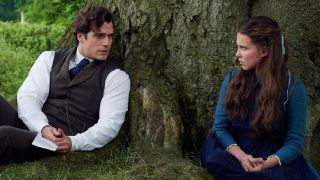 Millie Bobby Brown's Enola Holmes speaking with Henry Cavill's Sherlock Holmes