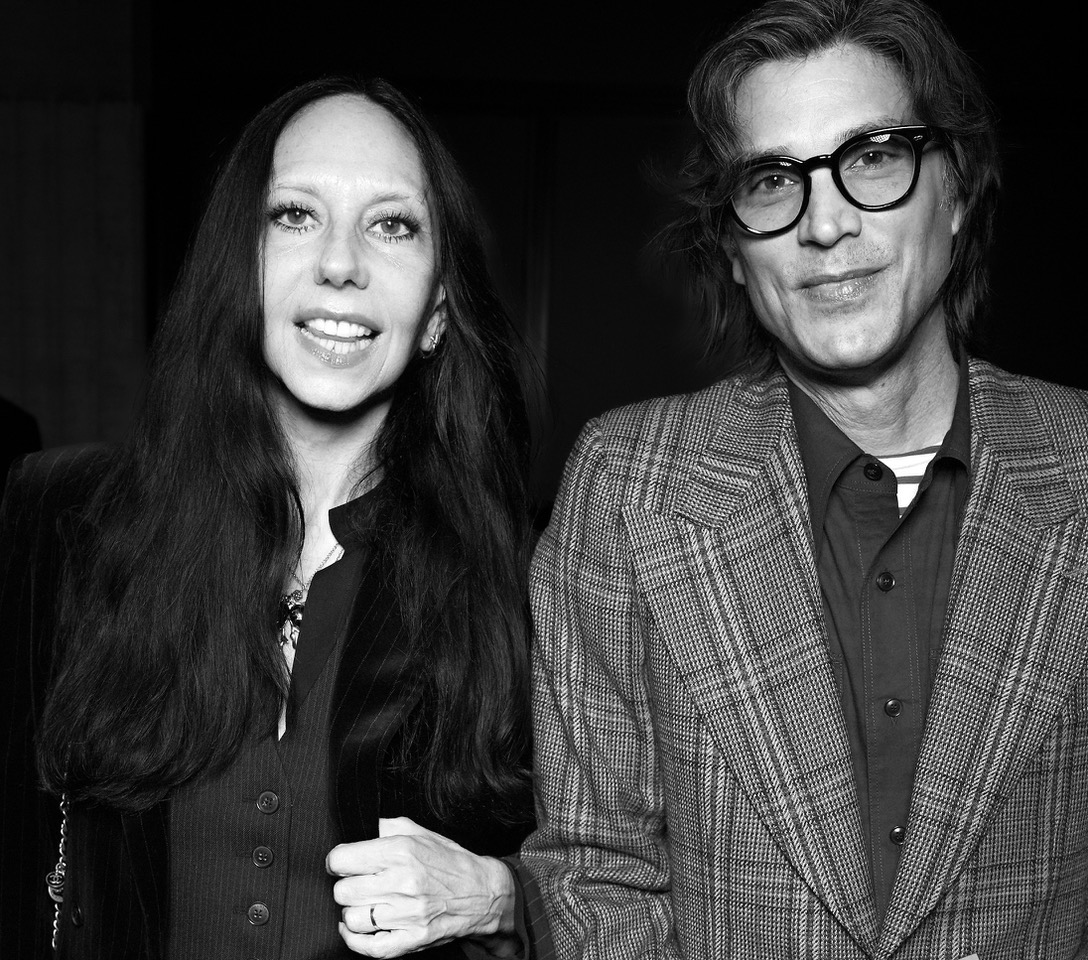man and woman with red sheet in the desert