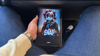 Kogan Explore Tab 2 Pro tablet playing Marvel Snap while travelling