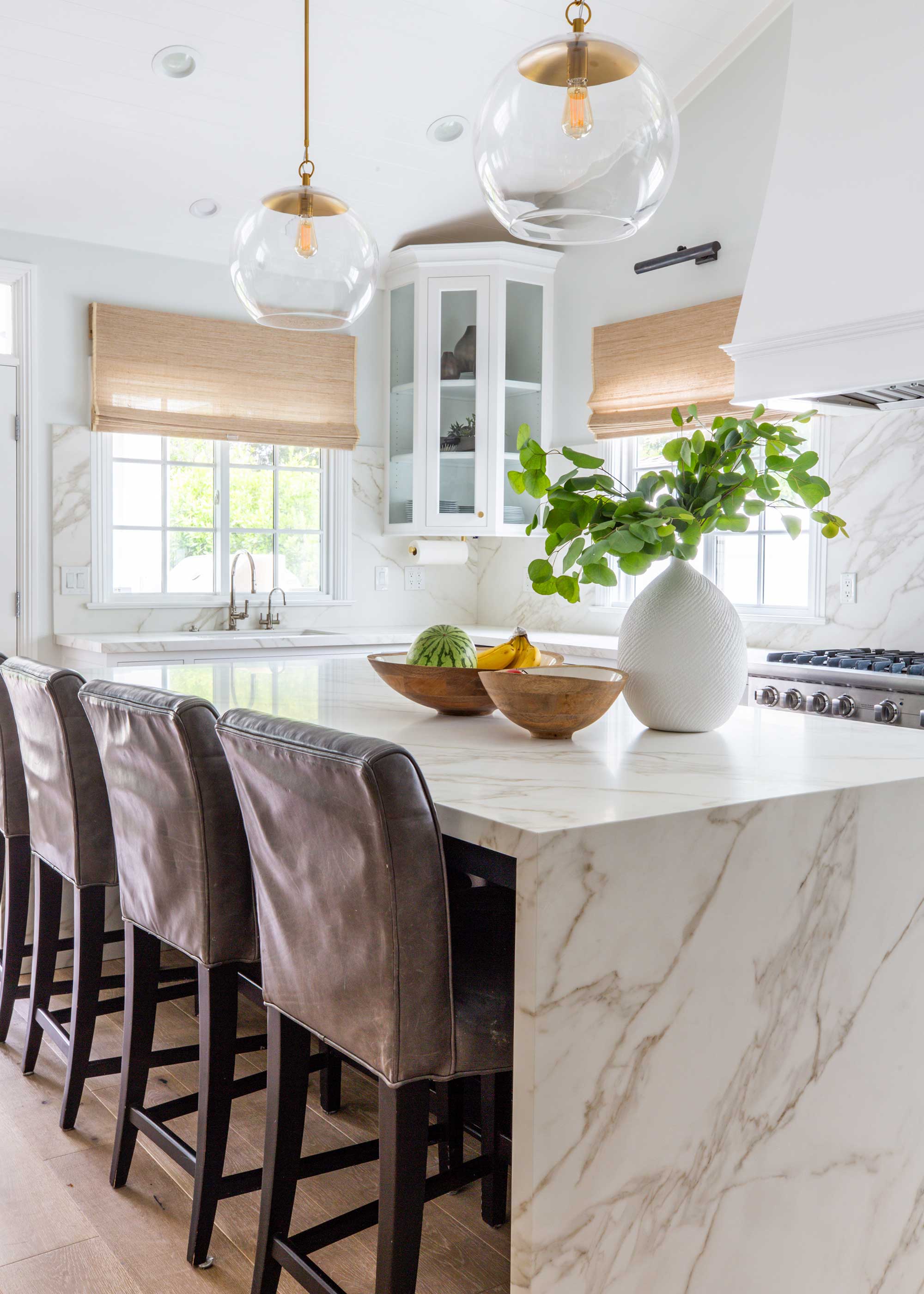 marble kitchen with brown leather stools