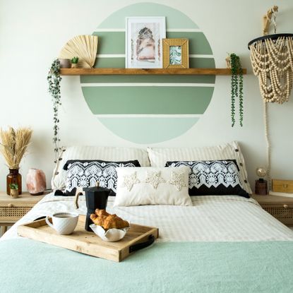 Bedroom with a breakfast tray on the bed and macrame wall decoration