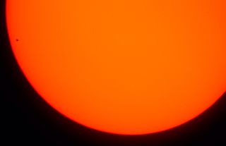 Super orange sun with tiny transit dot