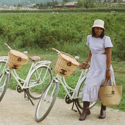 Deena in front of bike in jasmine field