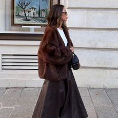 Aimee Song wearing a brown coat and skirt