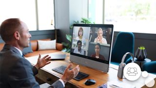 Man chatting with four people by via video on his computer monitor