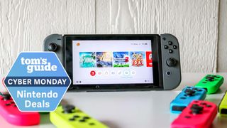 A Nintendo Switch surrounded by Joy-Cons with a Tom's Guide Cyber Monday badge