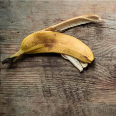 A banana peel on a wooden floor