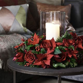 CandleWreath-poinsettia on side table with couch in background