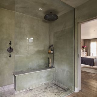 concrete shower room with bench
