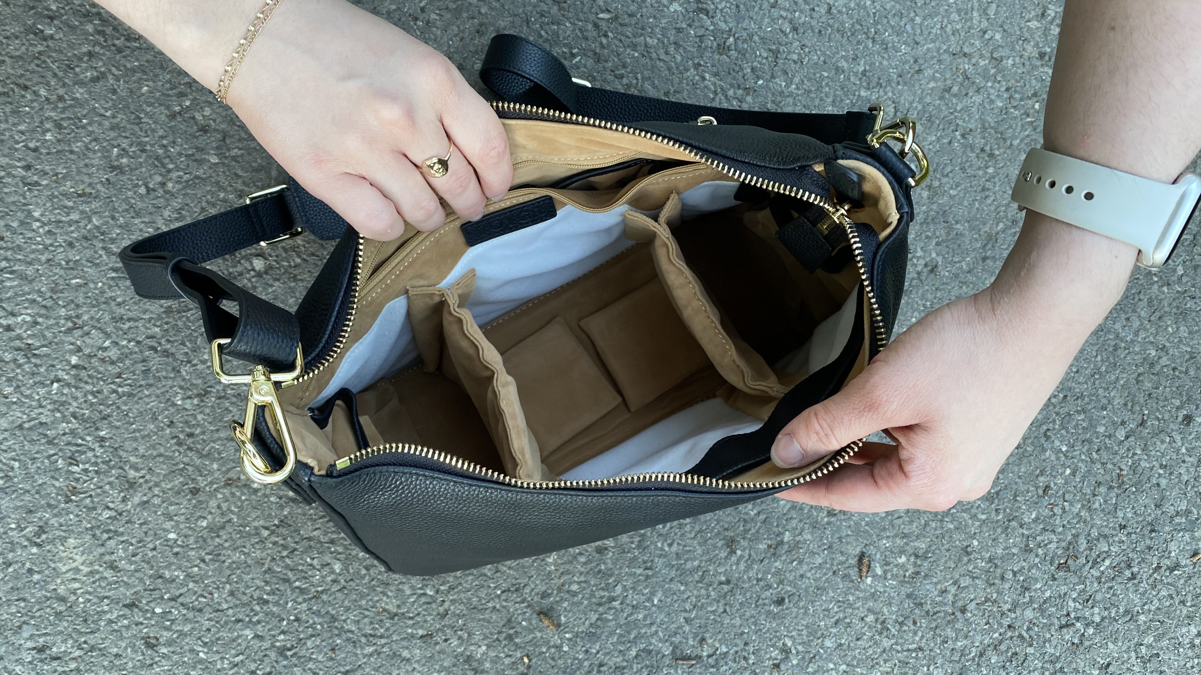 Person opening an empty Voygr 1 camera bag