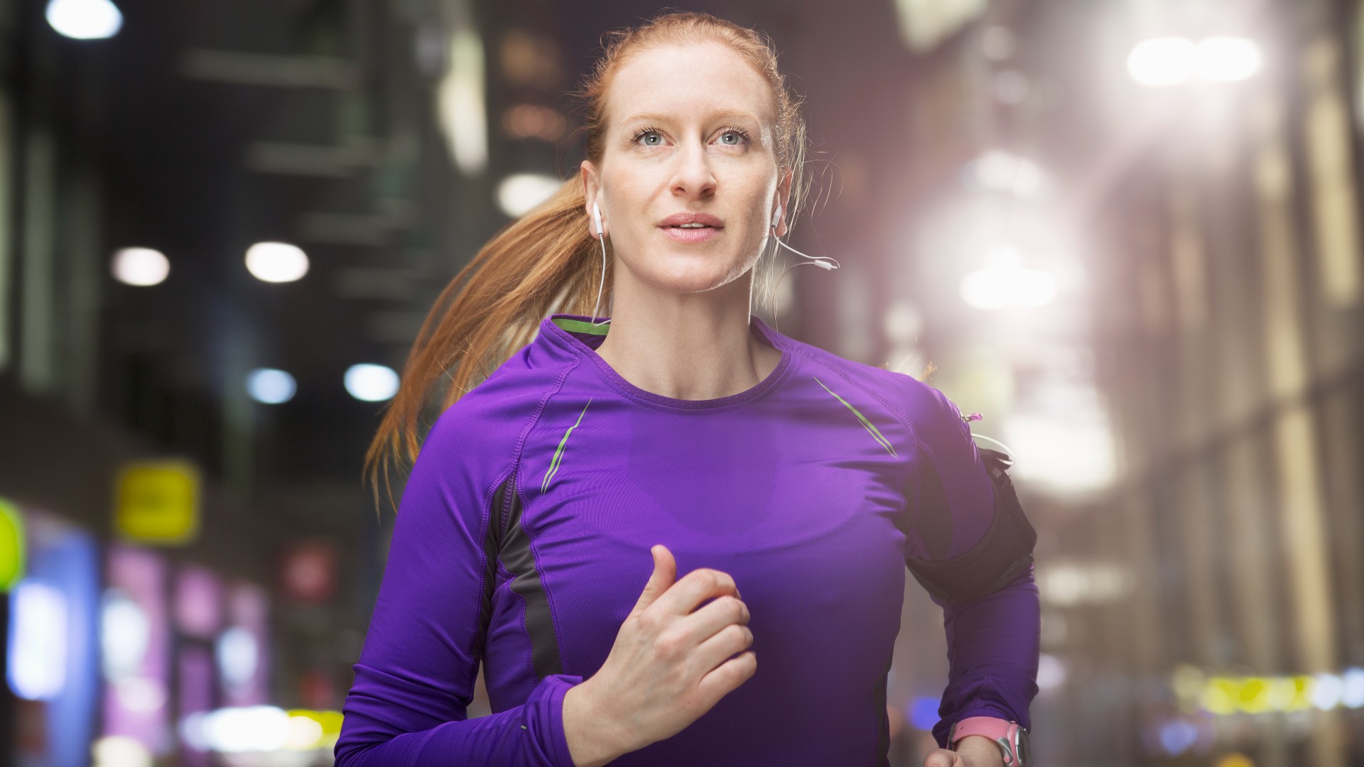 Woman running in the city at night