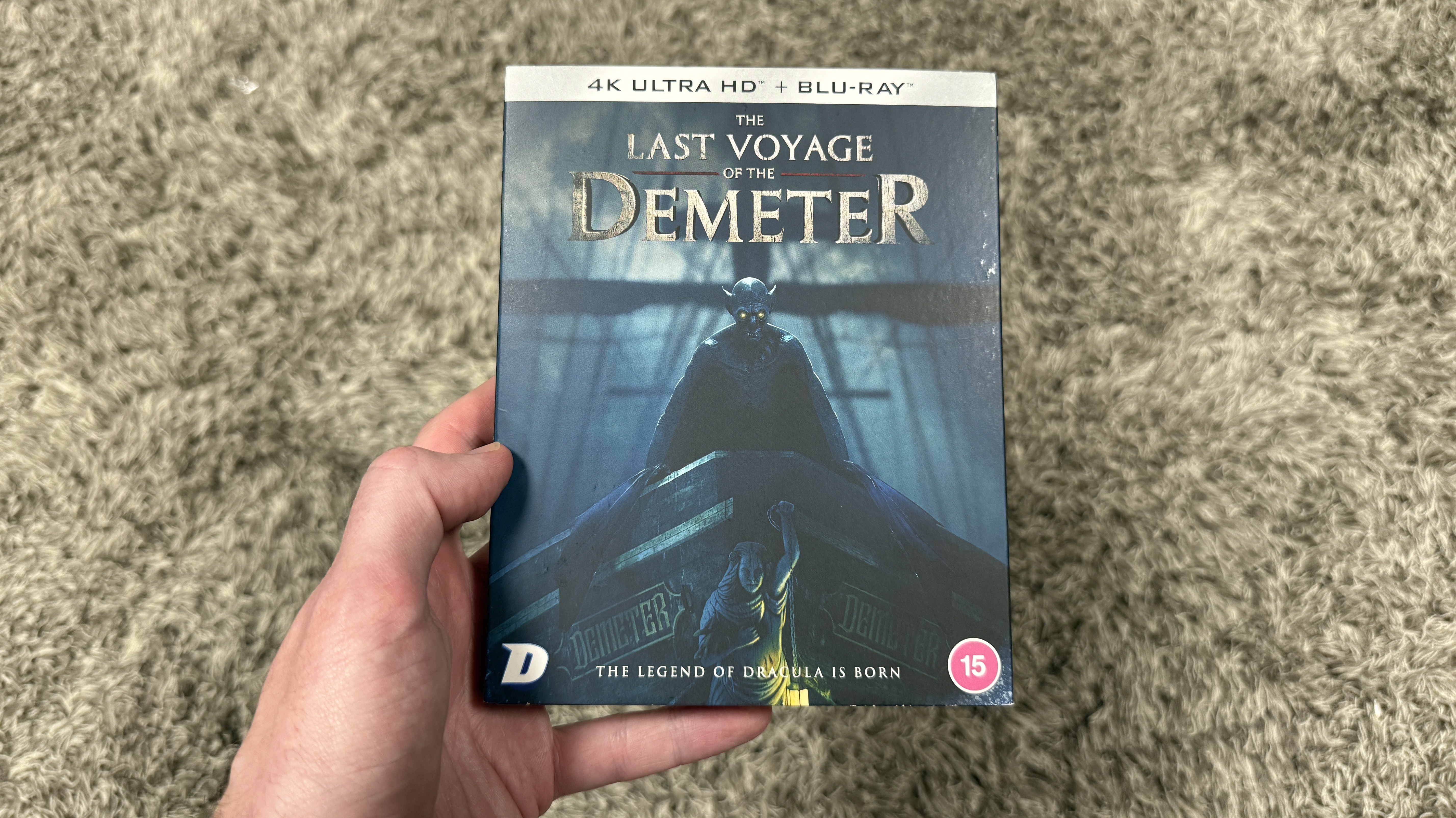 The Last Voyage of the Demeter Blu-ray box held in a man's hand