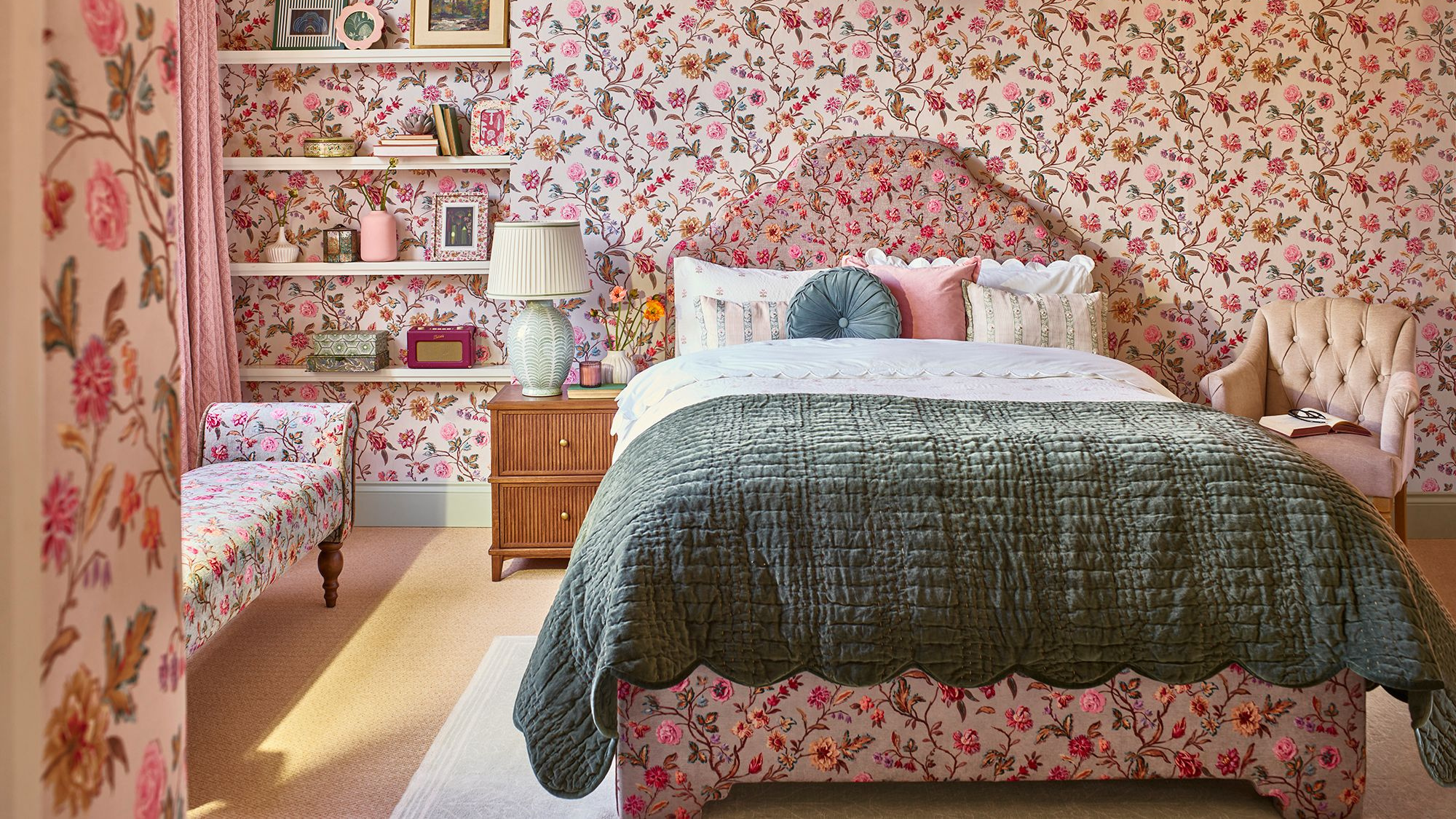 Room with floral wallpaper and matching bedframe and bench