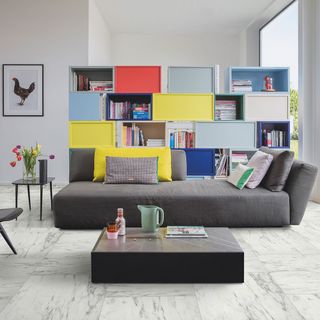 living room with grey sofa and laminated book shelf