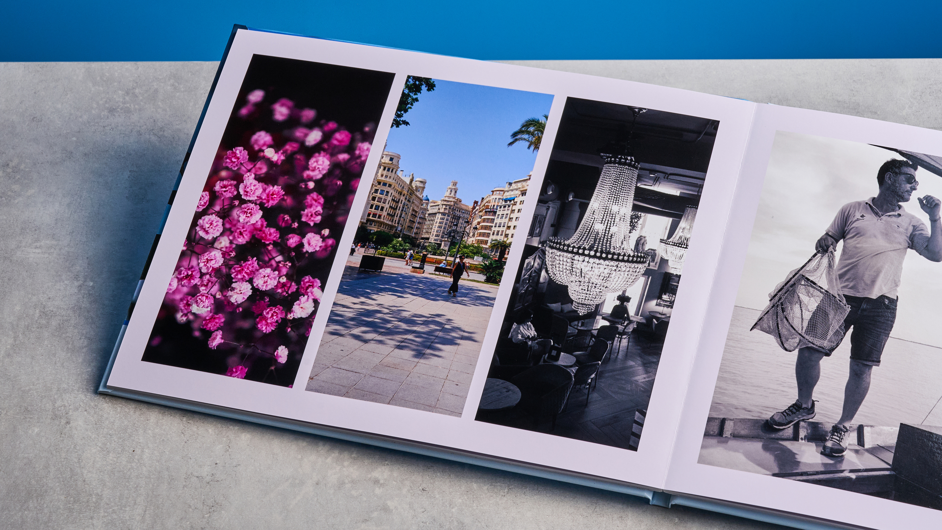 Popsa photo book photographed in front of a blue background