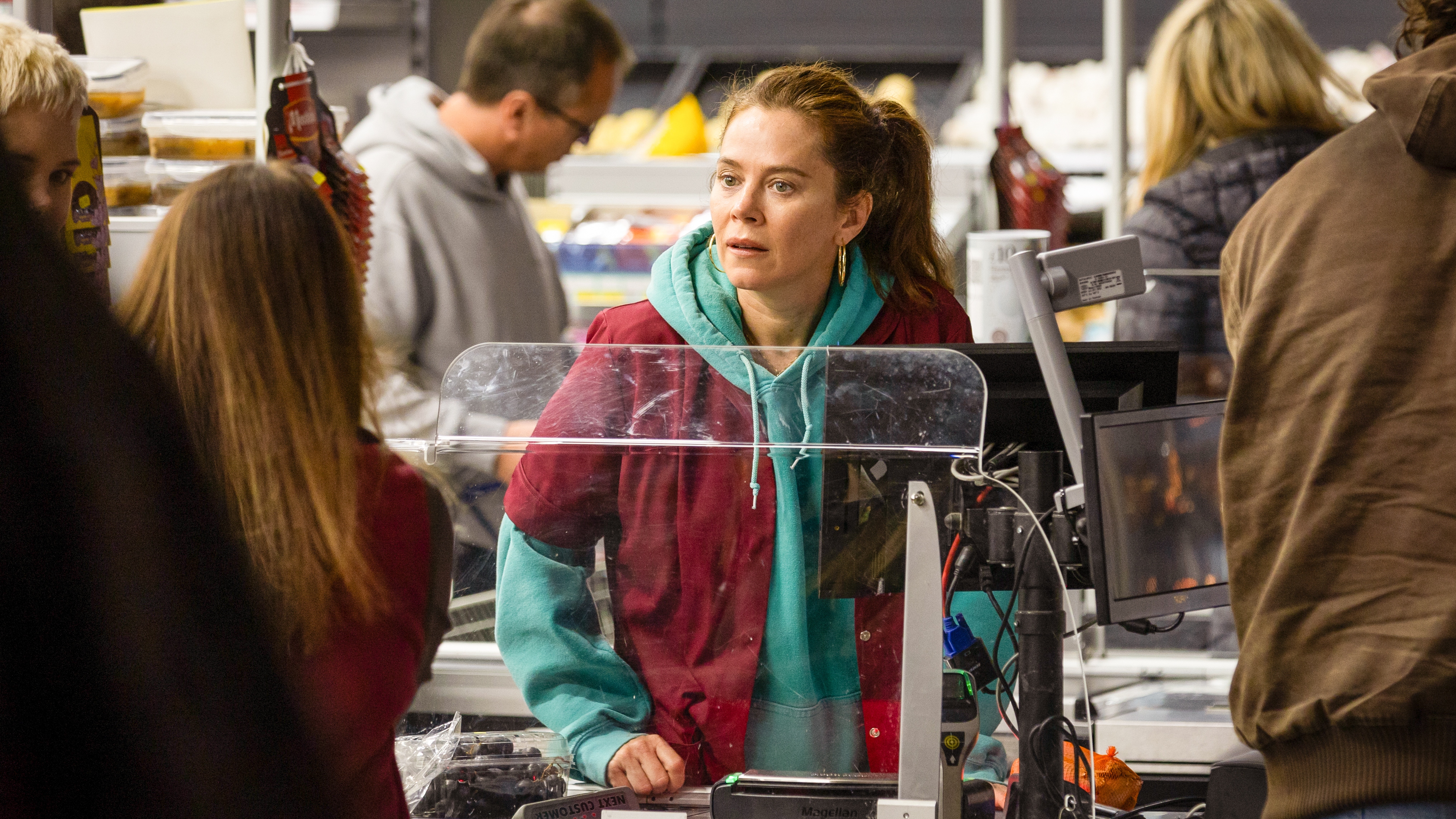 Anna Friel as Anna speaking to a shop worker at a supermarket counter in Unforgivable