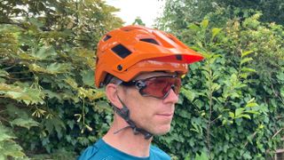 A man wearing a mountain bike helmet
