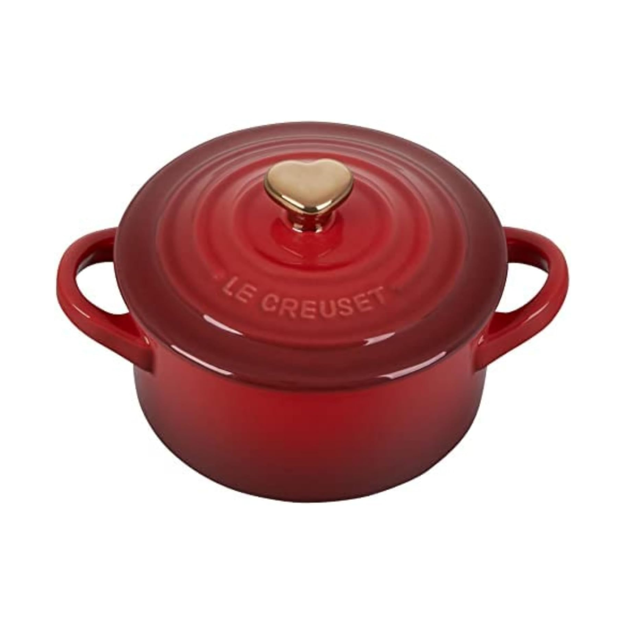 le creuset mini round dutch oven in cherry red with a heart handle on the lid