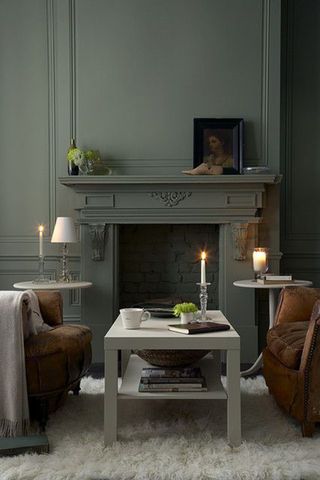A dark green living room with fireplace