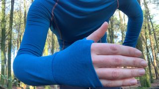 Close up of runner's hand showing thumb loops on base layer