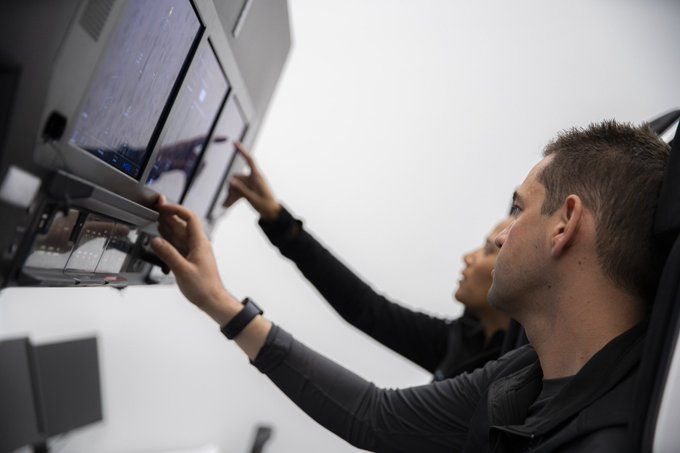 Jared Isaacman (foreground) and Sian Proctor (background) train for Inspiration4 at SpaceX HQ.