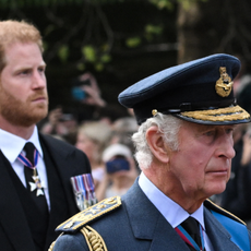 Britain's King Charles III and Britain's Prince Harry, Duke of Sussex walk behind the coffin of Queen Elizabeth II