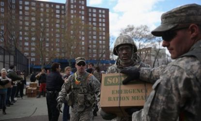 National Guard troops deliver food to the Red Hook public housing projects in the Brooklyn borough of New York City on Nov. 3. The low-income apartment building remains without power or water