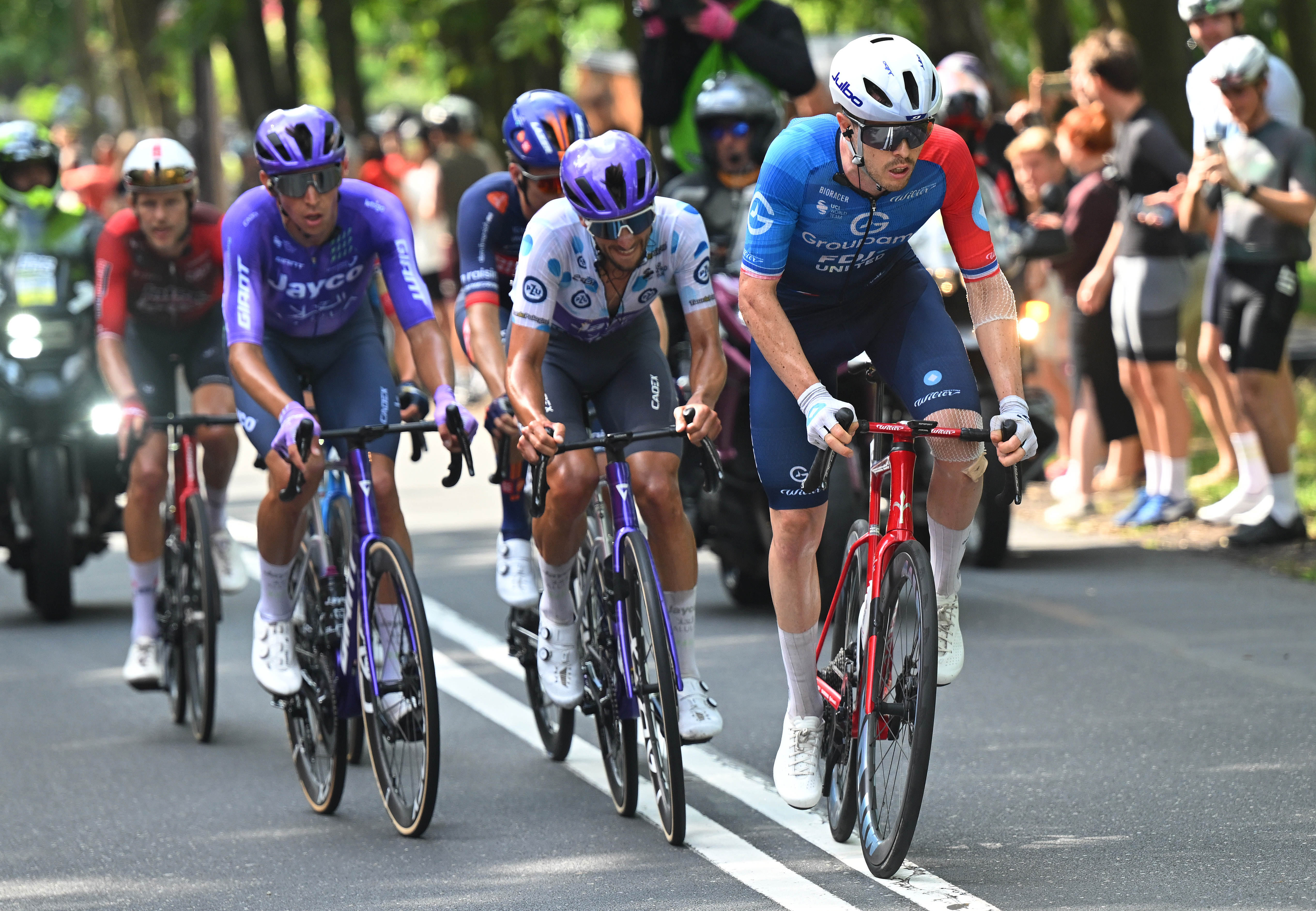 Dries De Bondt of Jayco AlUla, in the Polka Dot Mountain Jersey, rides in the breakaway, led by Remi Cavagna of Team Groupama - FDJ United