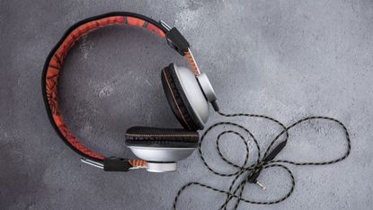 Pair of modern black and orange headphones 