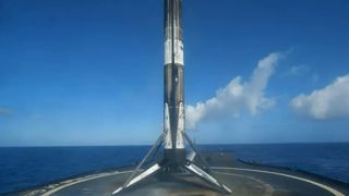 A SpaceX Falcon 9 first stage stands on the droneship A Shortfall Of Gravitas after a successful fourth landing following its launch of the Starlink 4-10 mission with 48 satellites on March 9, 2022.