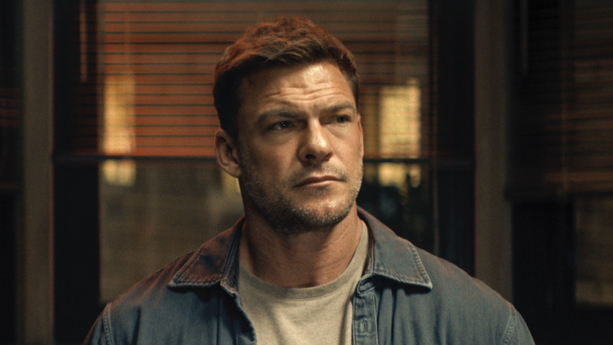 Reacher sitting at table being interrogated in Reacher Season 4