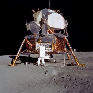 Buzz Aldrin taking equipment off the lunar module during the Apollo 11 mission.