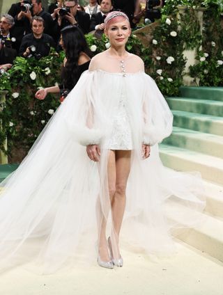 Michelle Williams at the 2024 Met Gala in a white high low train dress
