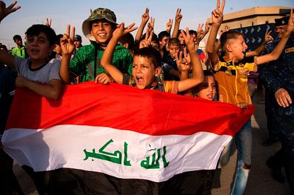Children celebrate the liberation of Mosul.