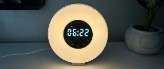 HomeLabs sunrise alarm clock with digital time on display surrounded by ring light.