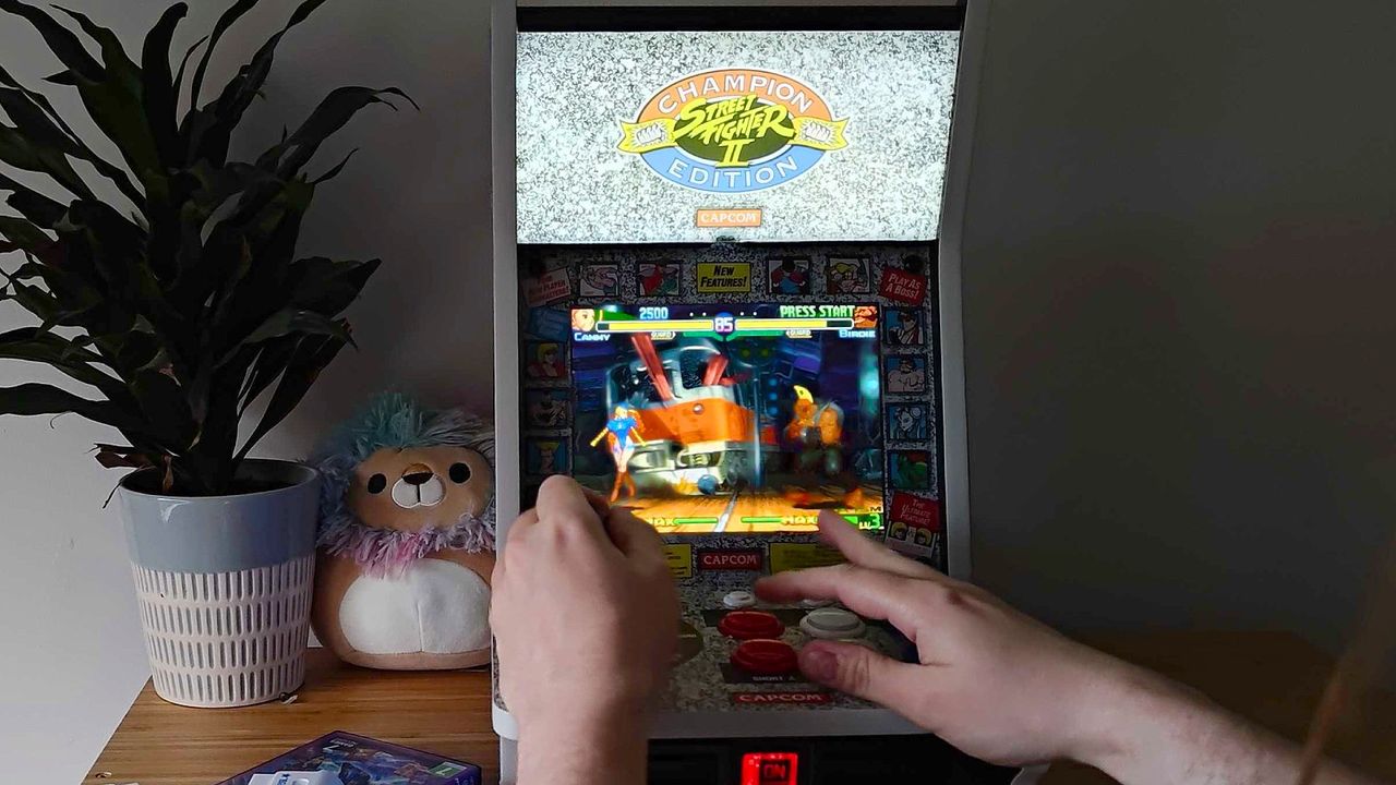 In motion photo of Evercade Alpha running Street Fighter Alpha 3 with Cammy vs Birdie