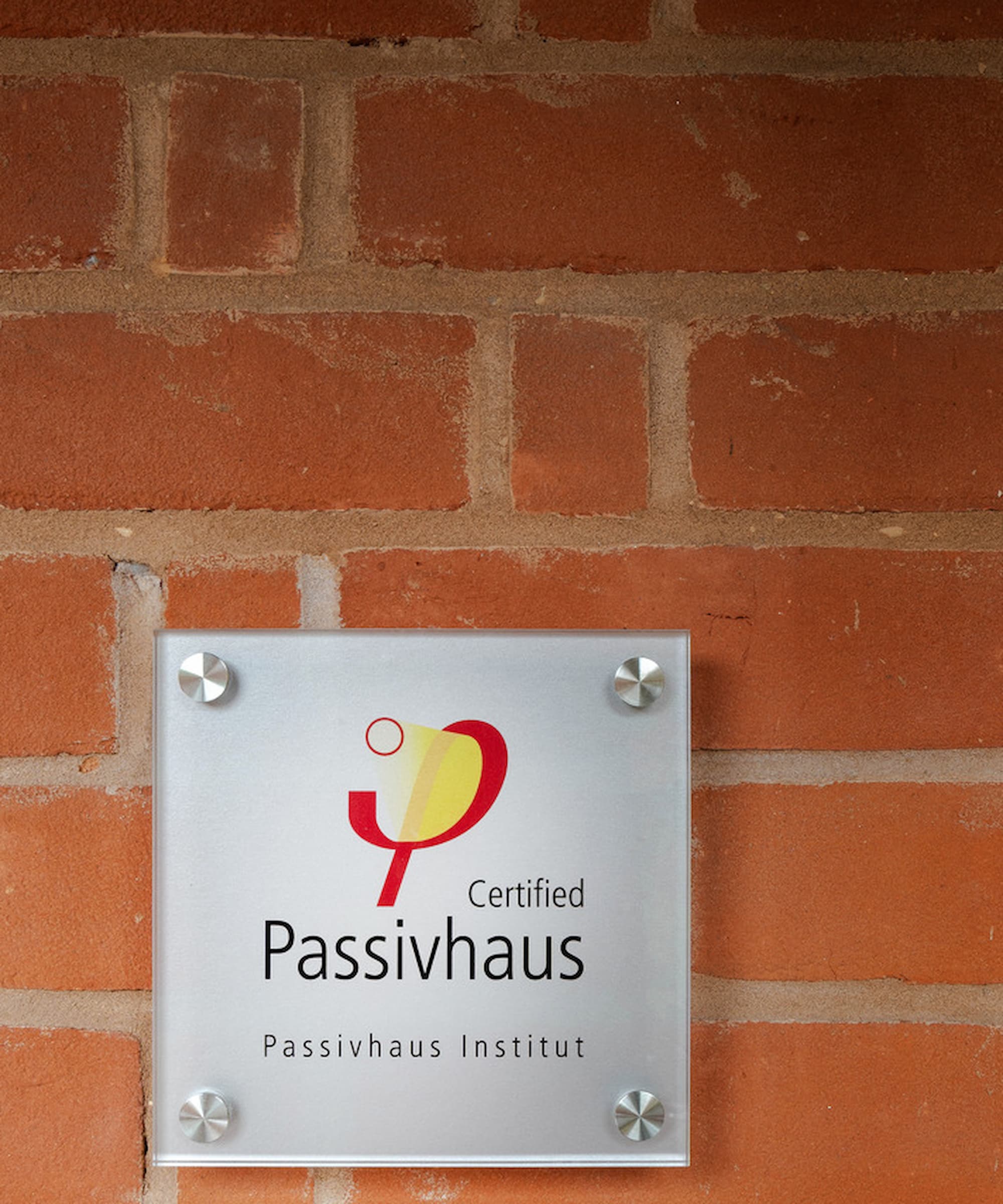 A certificate of Passivhaus standards being met on the entrance of the house