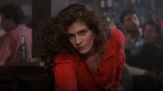 Julia Roberts standing by a pool table in Mystic Pizza.