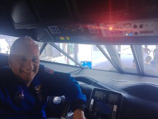 Mike Massimino poses in the front of the concept rover.