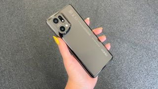 Oppo Find X5 Pro review: hand with yellow nails holding a phone